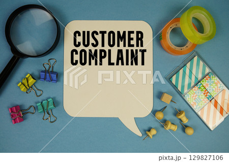 Customer Complaint text with magnifying glass on blue background Customer Complaint text with magnifying glass on blue background 129827106