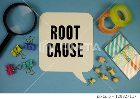 Root Cause text with magnifying glass on blue background 129827117