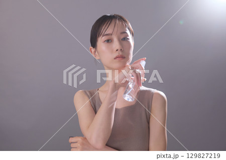 ビューティーイメージ 化粧水を持っている若い女性 129827219