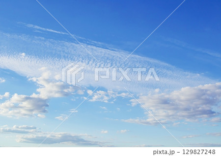 Cirrocumulus stratiformis clouds against blue sky. Beautiful sky with tiny clouds.  129827248