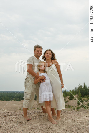 Smiling family. Father, mother and daughter outdoors Smiling family. Father, mother and daughter outdoors 129827290