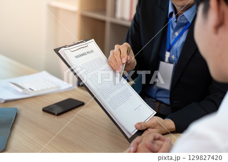 Business Insurance Consultation with Client Discussing Policy Details 129827420