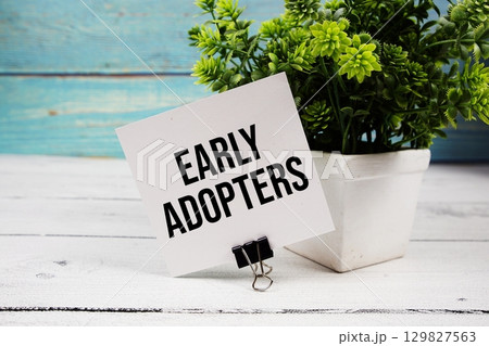 Early Adopters text written on paper card on wooden background Early Adopters text written on paper card on wooden background 129827563