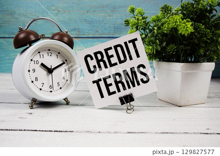 Credit Terms text written on paper card with alarm clock on wooden background Credit Terms text written on paper card with alarm clock on wooden background 129827577