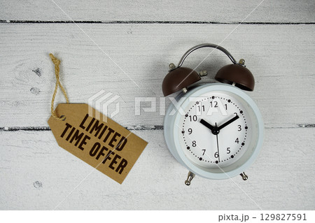 Limited Time Offer text with alarm clock on wooden background Limited Time Offer text with alarm clock on wooden background 129827591
