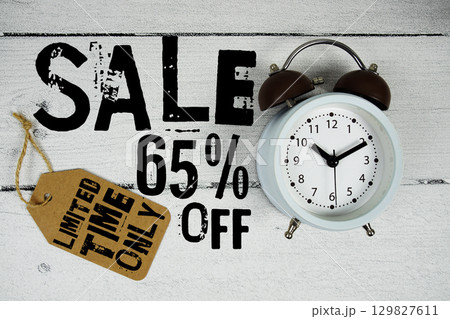 Sale 65% of Limited Time Only text with alarm clock on wooden background Sale 65% of Limited Time Only text with alarm clock on wooden background 129827611