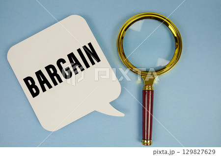 Bargain text with magnifying glass on blue background Bargain text with magnifying glass on blue background 129827629