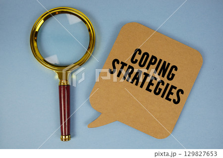 Coping Strategies text with magnifying glass on blue background Coping Strategies text with magnifying glass on blue background 129827653