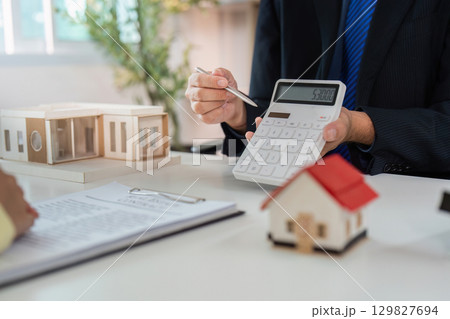 Real Estate Financial Calculation. Agent presenting property costs to client. Real Estate Financial Calculation. Agent presenting property costs to client. 129827694