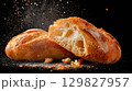 Enjoying fresh ciabatta bread on a dark background 129827957