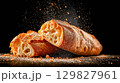 Freshly baked ciabatta bread on dark surface 129827961