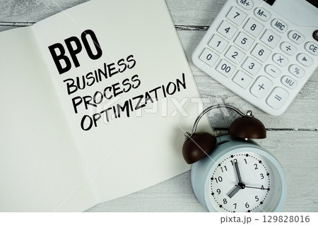 BPO Business Process Optimization text on paper notebook page with alarm clock and calculator on wooden background BPO Business Process Optimization text on paper notebook page with alarm clock and calculator on wooden background 129828016