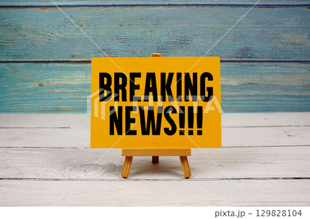 Breaking News text written on paper card on wooden background Breaking News text written on paper card on wooden background 129828104