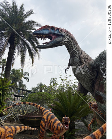 Pattaya, Thailand - Jul 31, 2025 : A large dinosaur in a 1:1 scale is displayed in the park of Nong Nooch garden, Pattaya, Thailand - Jul 31, 2025 : A large dinosaur in a 1:1 scale is displayed in the park of Nong Nooch garden, 129830206