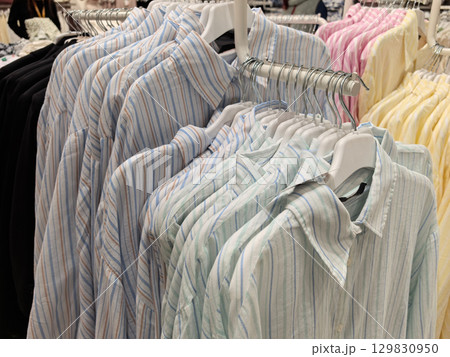 Colorful shirts neatly displayed in a retail clothing store 129830950