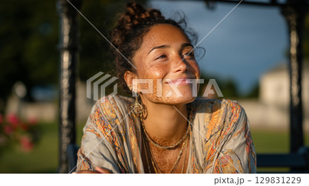 Smiling young woman with vitiligo enjoying a sunny afternoon outdoors 129831229