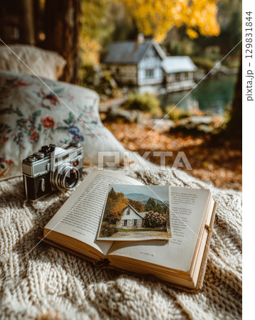 Memories captured in an autumn park with an open album on a cozy blanket 129831844