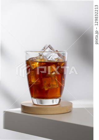 Iced americano in a glass on a white table in the cafe. 129832213