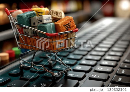 Digital Shopping Cart Overflowing with Diverse Products on Keyboard Background 129832301