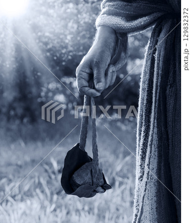 Man's hand with an old sling 129832372