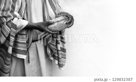 Man's hans holding fresh bread Man's hans holding fresh bread 129832387