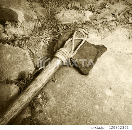 Stone ax of a primitive man 129832391