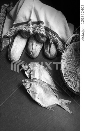 Bread and fish on the table 129832402