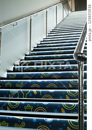 Illuminated stairs with modern design, featuring creative patterns. The glowing effect emphasizes depth, creating sense of movement and future forward architecture Illuminated stairs with modern design, featuring creative patterns. The glowing effect emphasizes depth, creating sense of movement and future forward architecture 129833016