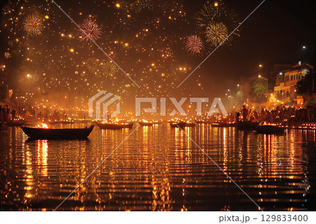 Fireworks during the Diwali festival of lights over a river. The lights of the fireworks are reflected in the water. 129833400