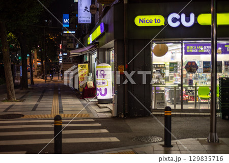 Night view of a CU convenience store on a quiet street corner in Seoul, South Korea 129835716