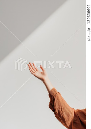 Woman in brown shirt raising hand, sunlight...のイラスト素材 [129836602] - PIXTA