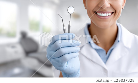 Dental professional holding tools in a bright clinic during a checkup 129837329