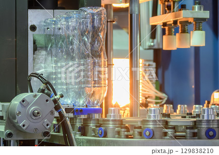 The drinking water bottle manufacturing process by blow mold machine. 129838210