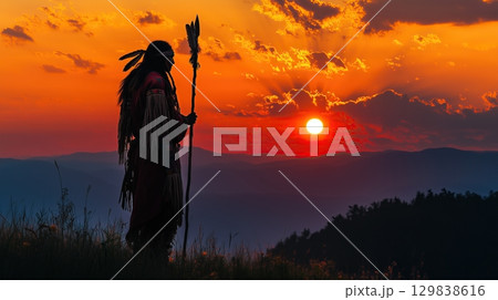 Silhouette of a Native American shaman with pikestaff on the backgroun. 129838616