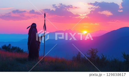 Silhouette of a Native American shaman with pikestaff on the backgroun. 129838617