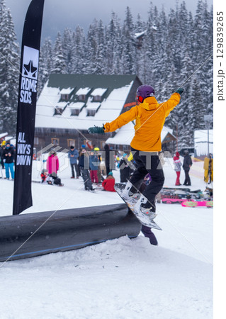 Dragobrat, Ukraine - April 8, 2023: Snowboarder t on Snowy Slope make a trick Dragobrat, Ukraine - April 8, 2023: Snowboarder t on Snowy Slope make a trick 129839265