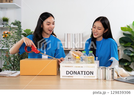 Volunteers teamwork packing donations for local charity 129839306