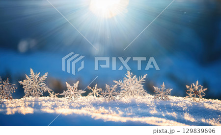 Sparkling snowflakes under bright sunlight convey purity and positive vibes 129839696