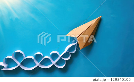 paper airplane soaring through bright blue sky, symbolizing creativity and innovation 129840106