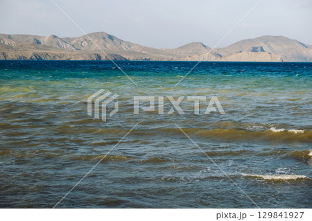 Seascape with mountains and waves forming colorful layers in Koktebel, Crimea 129841927