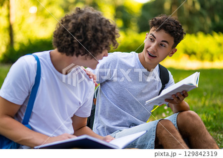 Teens learning lessons and looking involved while reading books 129842319