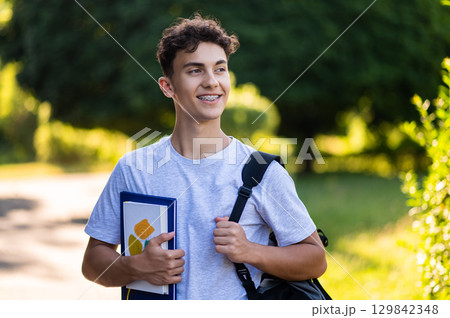 Dark-haired teenager in casual clothes looking good and happy 129842348