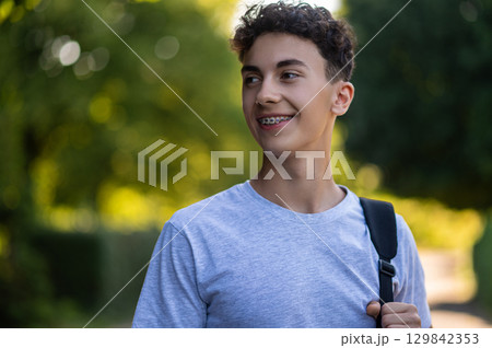 Dark-haired teenager in casual clothes looking good and happy Dark-haired teenager in casual clothes looking good and happy 129842353