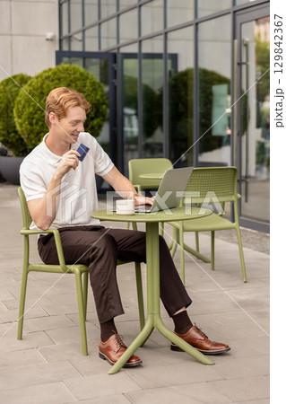 Self-employed male working online submitting card details completing shopping Self-employed male working online submitting card details completing shopping 129842367