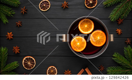 Warm spiced beverage brewing with oranges and spices during the winter season 129842426