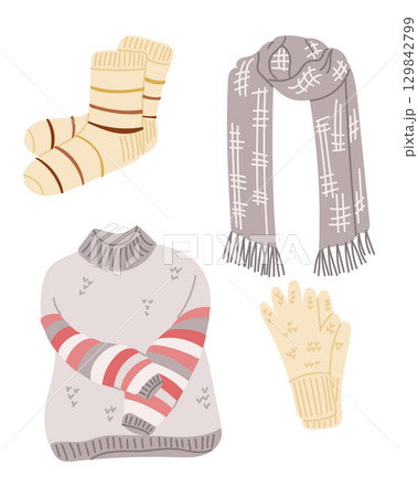 Warm winter clothing set including socks, scarf, gloves, and striped sweater in soft cozy colors 129842799