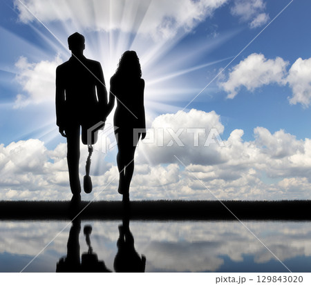 Disabled person with a prosthetic leg, walking with a woman Disabled person with a prosthetic leg, walking with a woman 129843020