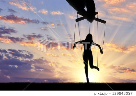 Woman's marionette. Manipulation concept Woman's marionette. Manipulation concept 129843057