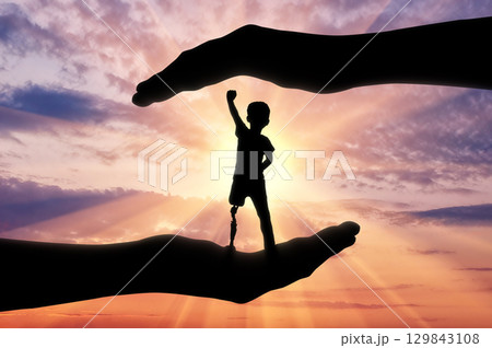 Happy disabled boy with a prosthetic leg standing 129843108