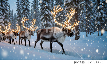Christmas reindeer walking through snowy forest with glowing lights on antlers in magical winter atmosphere 129843396